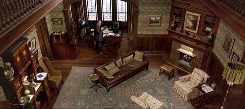 Old style english home library room, with large carpet, multiple desks and lots of wood and books from the movie My Fair Lady