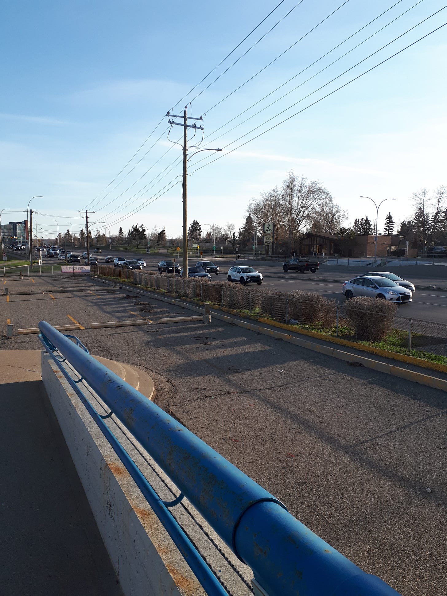 End of pedestrian ramp that ends in an empty parking lot.