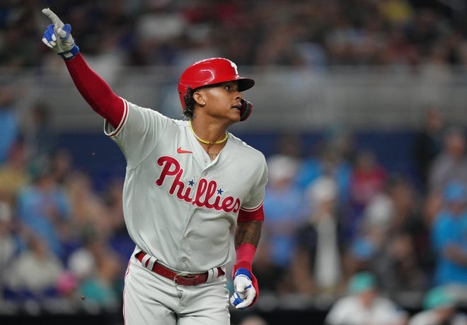Philadelphia Phillies pinch hitter Cristian Pache watches his two-run homer in the ninth inning clear the wall against the Florida Marlins.