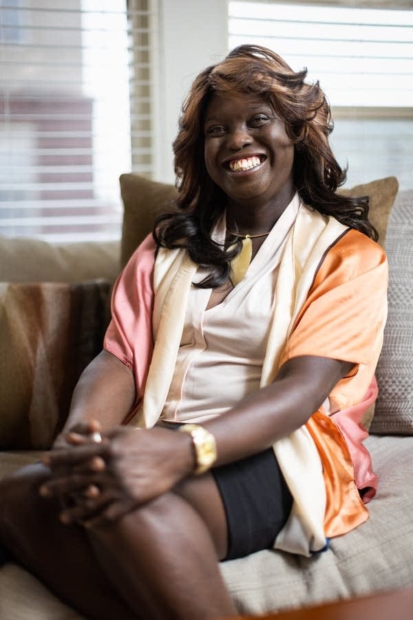 A Black woman smiles for a portrait