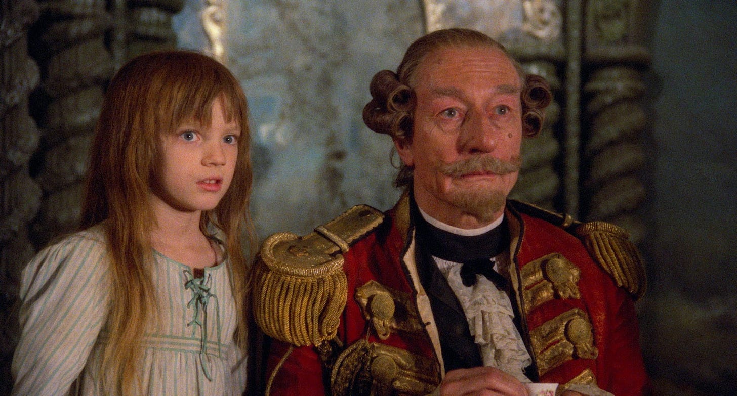 Still of Sarah Polley and John Neville in The Adventures of Baron Munchausen, directed by Terry Gilliam.