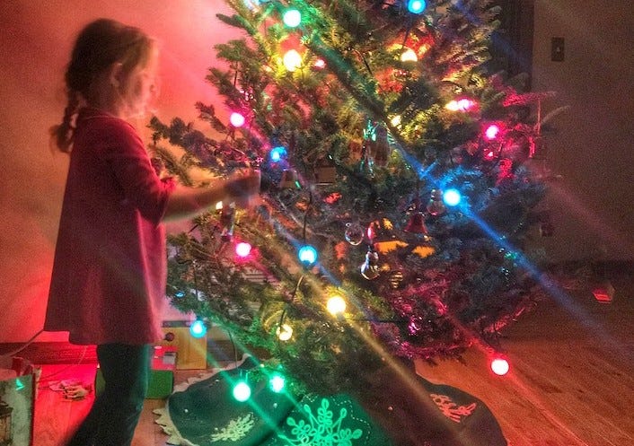 Daughter decorating tree