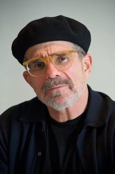 White guy with short gray beard in yellow glasses and a beret.