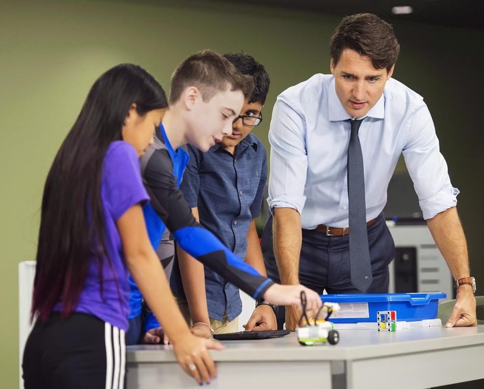 Prime Minister Justin Trudeau visits with students at a high school in Kapuskasing, Ont.