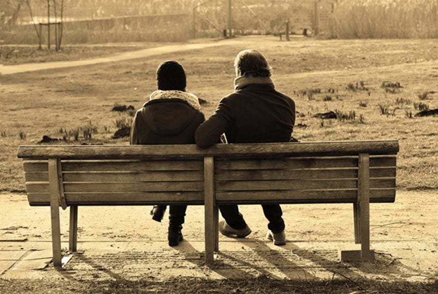 couple on a bench having a conversation