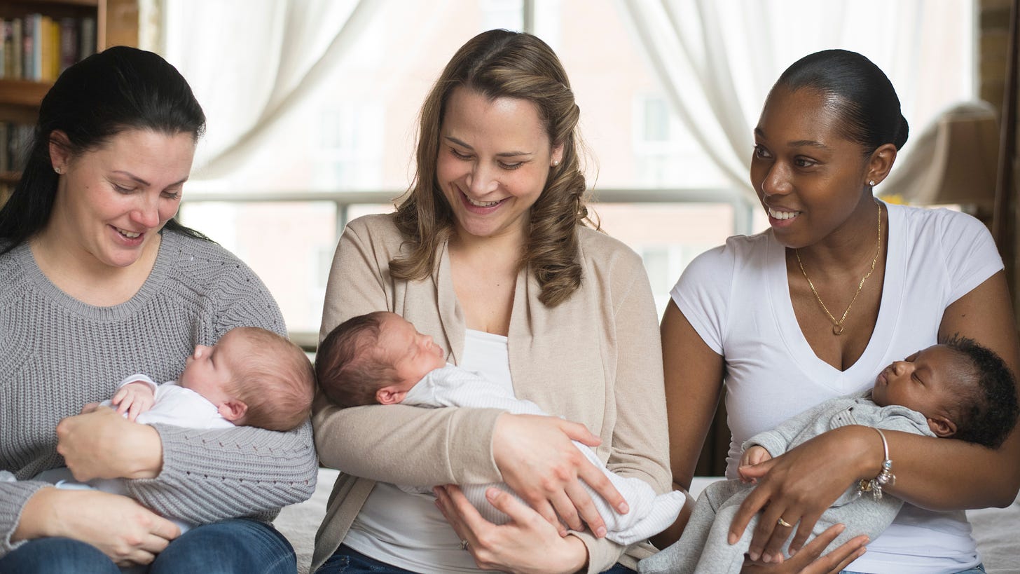 Picture of two white moms and a Black mom holding their newborn babies