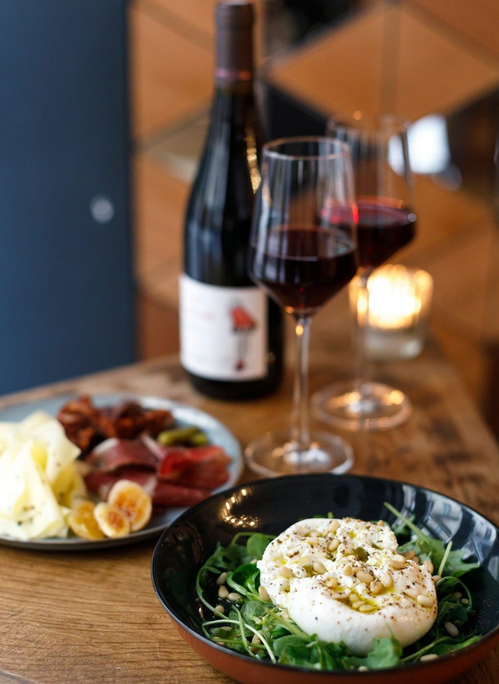 a plate of food and a glass of wine on a table a plate of food and a glass of wine on a table