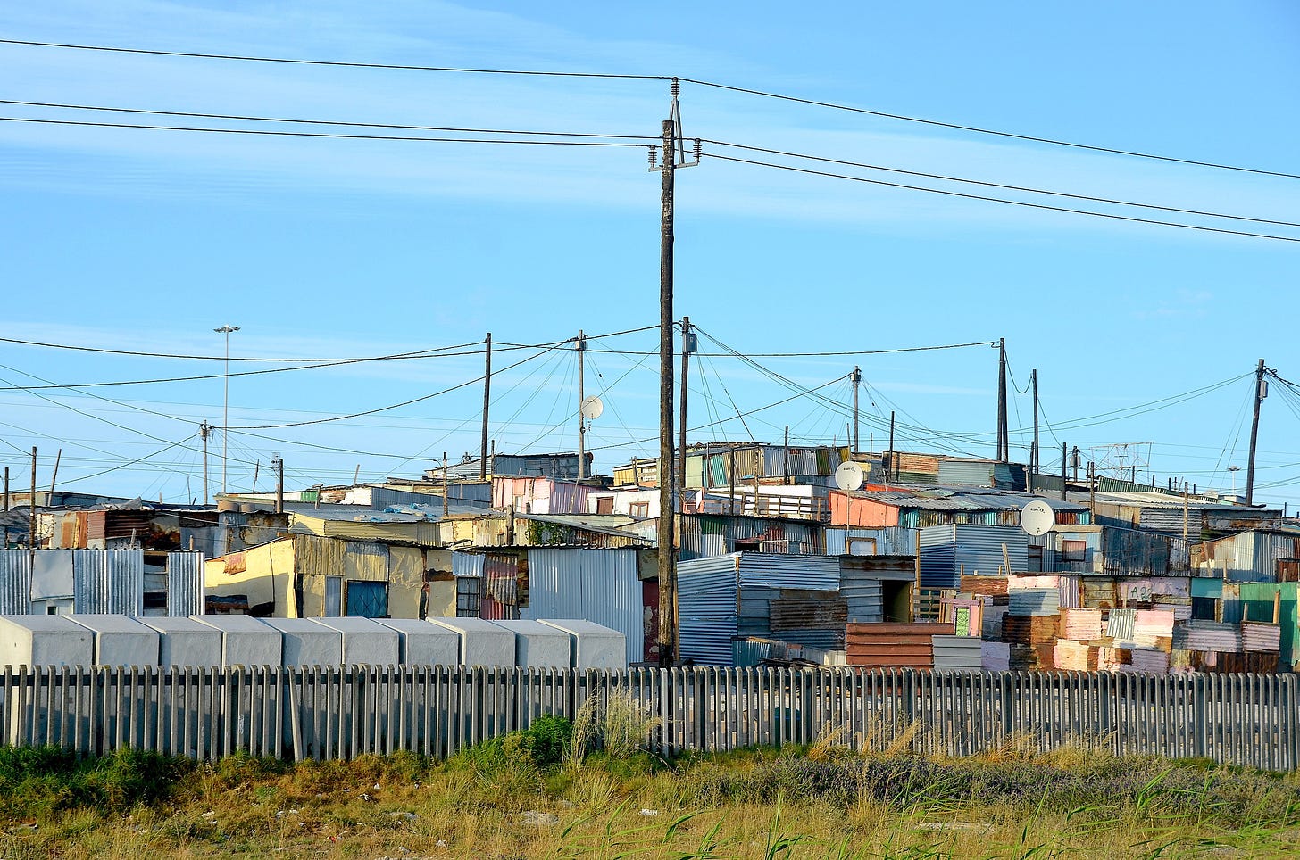 Photograph of shacks made out of corrugated metal and wood