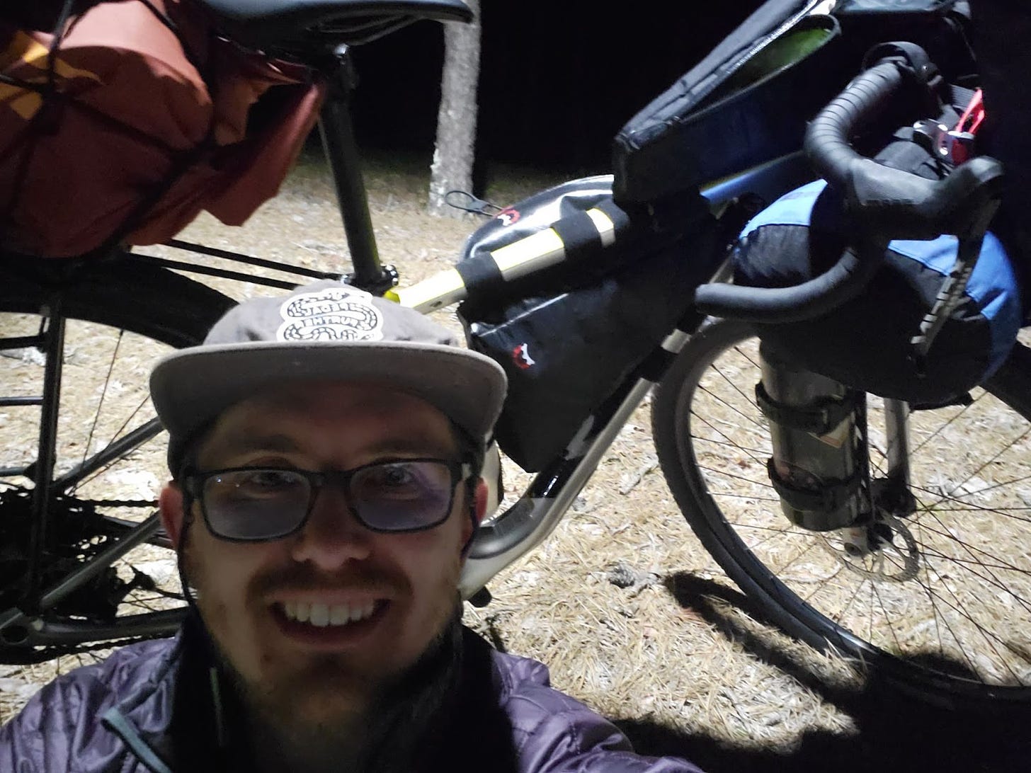 Michael smiles in front of his bike