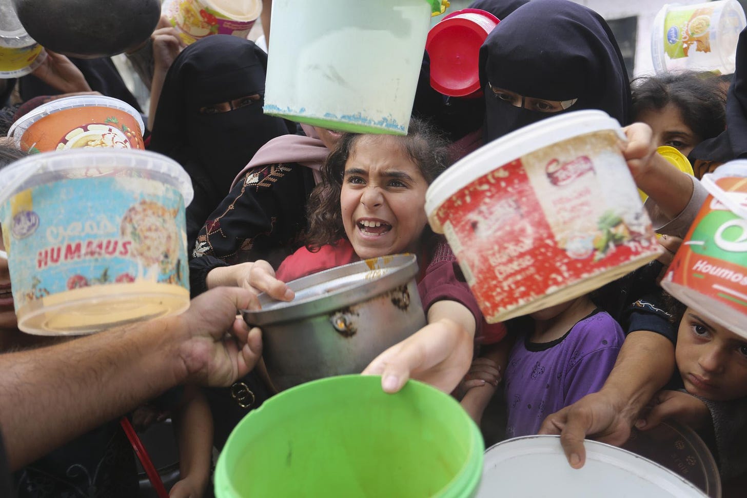 Palestinians line up for food during the ongoing Israeli bombardment of the Gaza Strip in Rafah on November 13, 2023. (AP Photo/Hatem Ali)