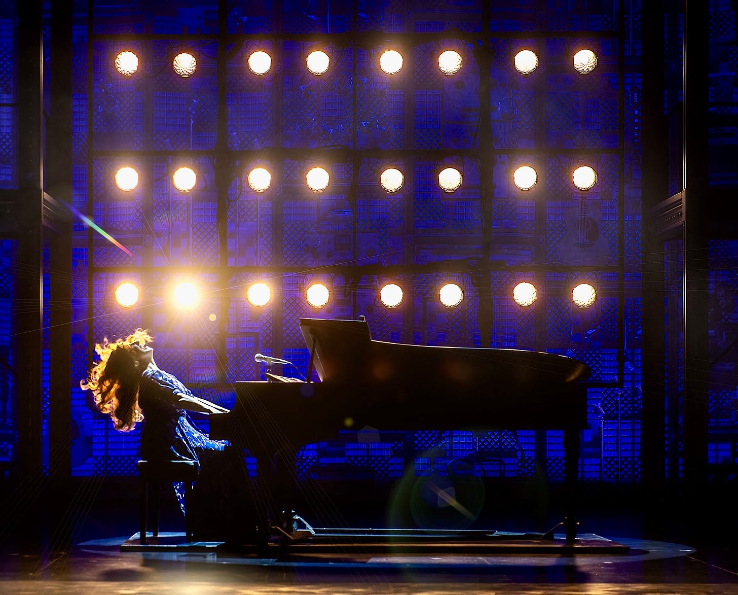 A woman playing the piano throws her long hair back