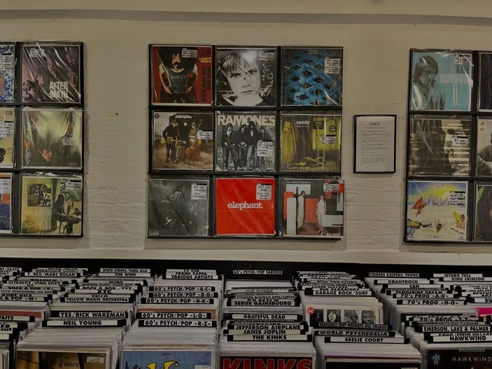 A collection of vinyl records on a wall

Description automatically generated