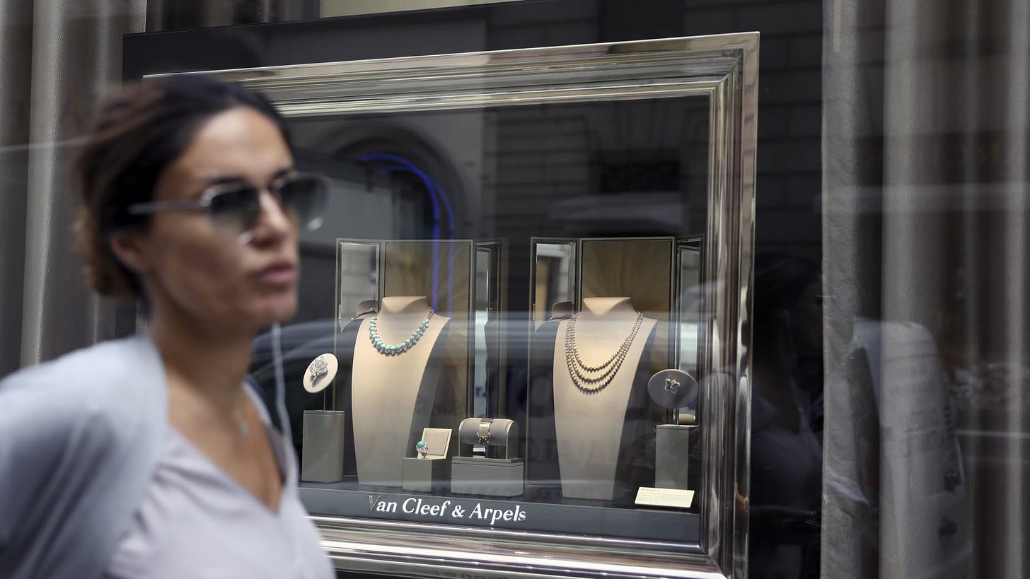 A pedestrian passes a jewelry display in the window of a Van Cleef & Arpels luxury goods store, operated by Cie. Richemont SA, on via Montenapoleone in Milan, Italy, on Tuesday, Oct. 1, 2019. The outlook for Europe's luxury-goods stocks just got bleaker, as UBS Group warned of Chinese clients' growing disaffection with brands like Richemont's Cartier, and Italy's Moncler SpA sounded the alarm about protracted social upheaval in Hong Kong. Photographer: Alessia Pierdomenico/Bloomberg via Getty Images