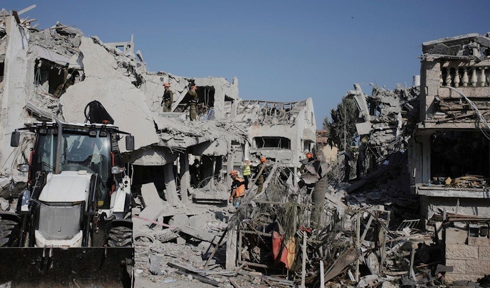 Israeli security forces inspect the site of homes destroyed by a missile fired from Iran, in Rishon Lezion, occupied Palestine, on Saturday, June 14, 2025. (AP) Israeli security forces inspect the site of homes destroyed by a missile fired from Iran, in Rishon Lezion, occupied Palestine, on Saturday, June 14, 2025. (AP)
