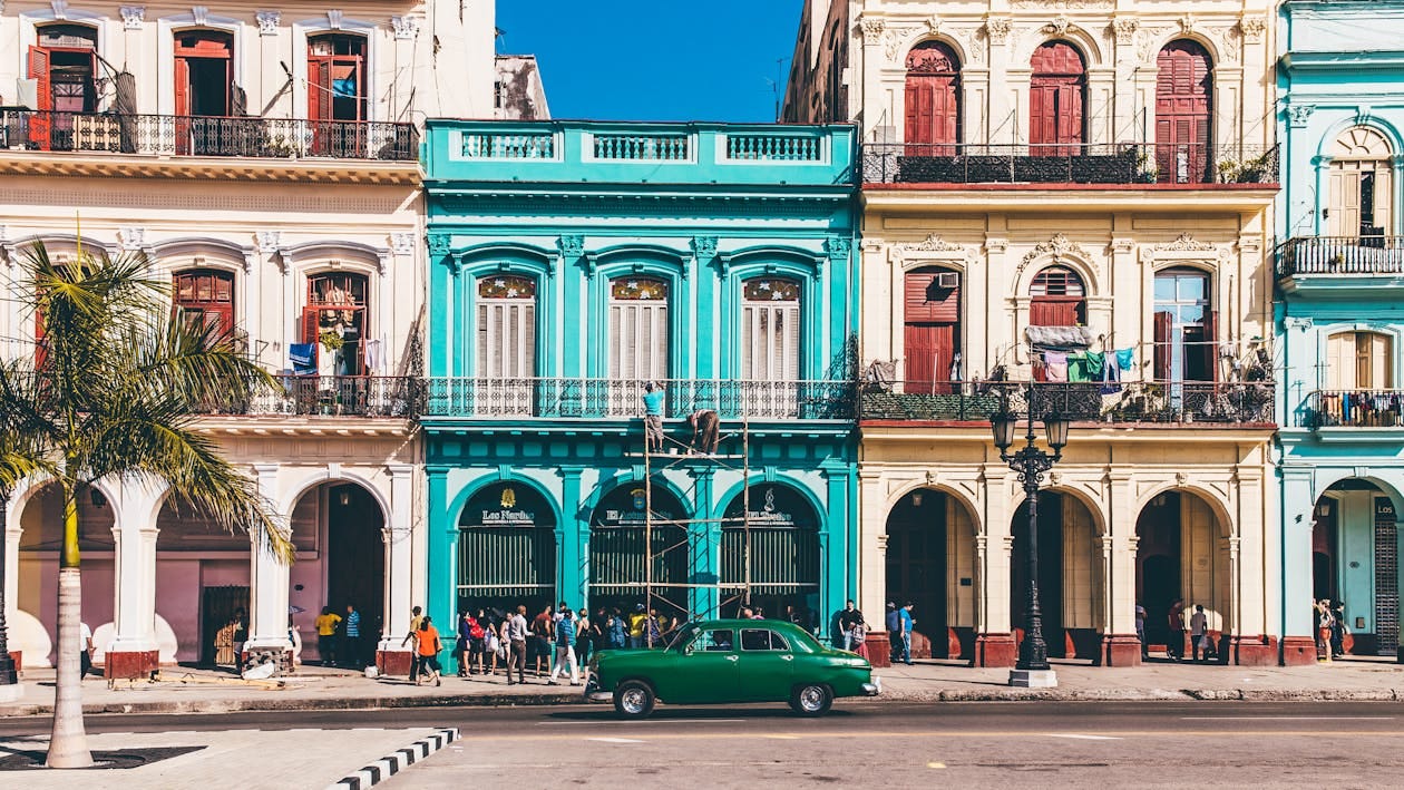 Free Vibrant colonial buildings and classic car on a sunny street in Havana, Cuba. Stock Photo