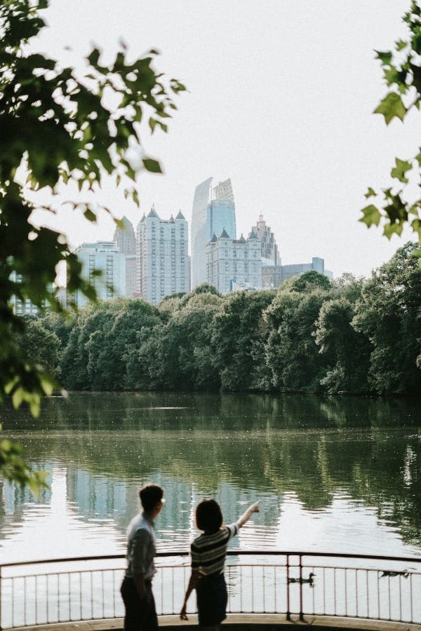 Image of couple at Atlanta’s Piedmont park enjoying a view of the skyline