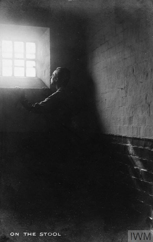 Copy negative made from a postcard of a conscientious objector prison. Original caption 'On the stool'.