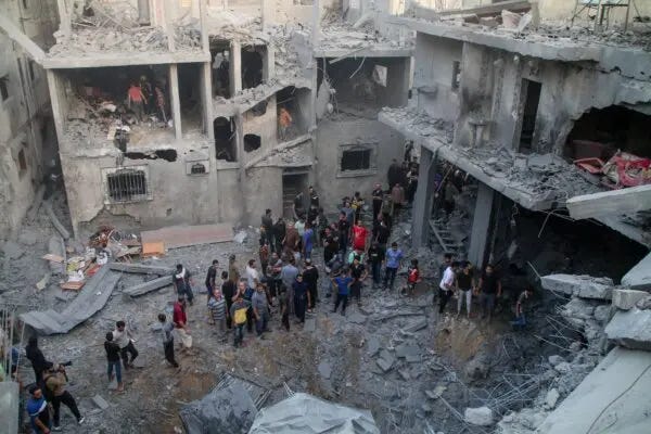 Palestinian emergency services and local citizens search for victims in buildings destroyed during Israeli air raids in the southern Gaza Strip, in Khan Yunis, Gaza, on Oct. 19, 2023. (Ahmad Hasaballah/Getty Images)