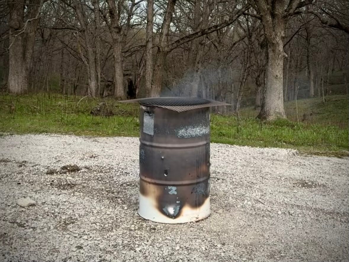 Burn barrel in a gravel driveway