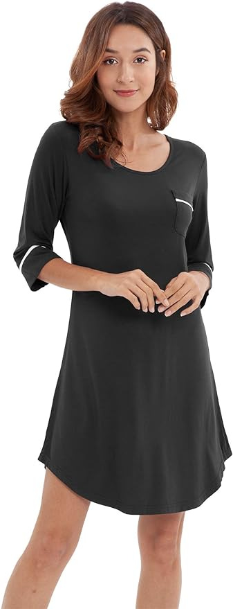 Brunette woman in black 3/4 sleeve knee length nightgown with white piping on sleeves and pocket