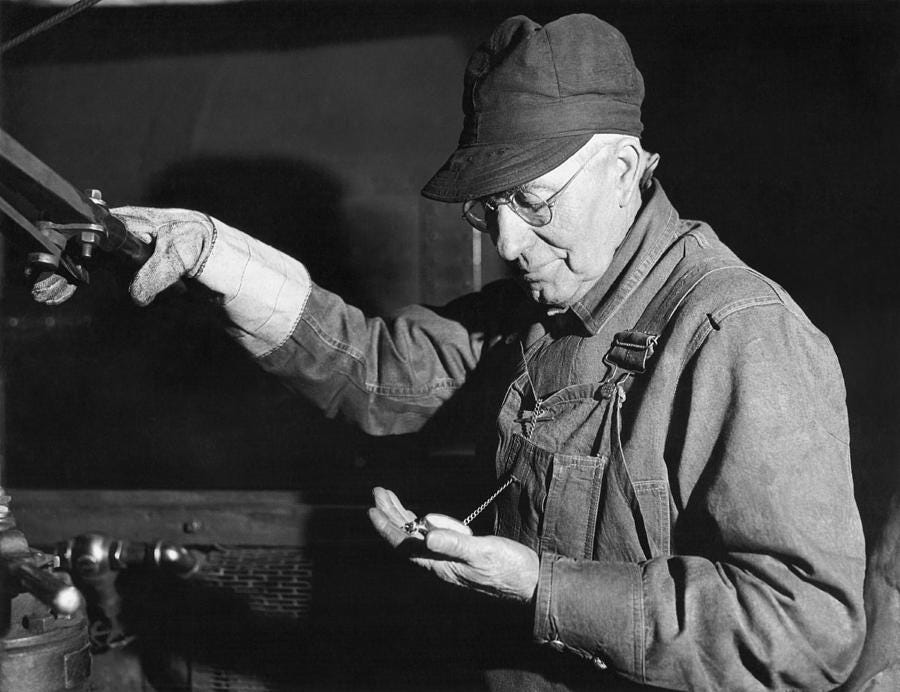 Railroad Engineer Checks Watch Photograph by Underwood Archives - Fine Art  America