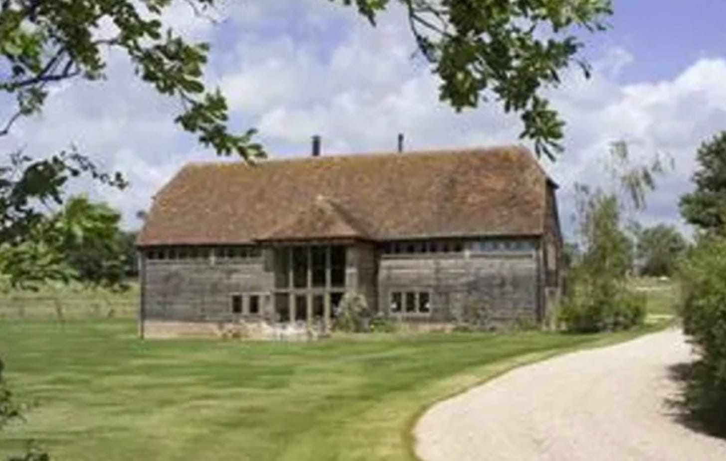 Elizabethan historic barn in a grassy field