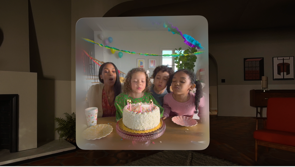 A spatial image floating in space. Four people are blowing out birthday candles.