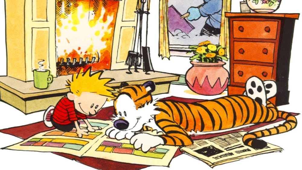 Calvin and Hobbes relax with some comics by the fire