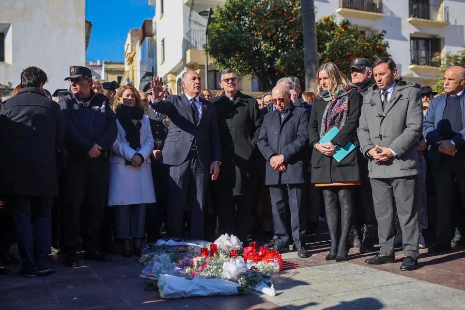 Nuestra Señora de La Palma church's priest Juan José Marina and Algeciras mayor José Ignacio Landaluce, center, gather with residents and other local authorities during a minute of silence for a church sacristan killed Wednesday in Algeciras, southern Spain, Thursday, Jan. 26, 2023. Residents of the Spanish city of Algeciras recounted their shock after a machete-wielding attacker jumped on the altar of a church before chasing a victim into a city square and inflicting mortal wounds. The attacks on two churches by a single assailant on Wednesday night have shaken the city near the southern tip of Spain across from a bay from Gibraltar. (AP Photo/Juan Carlos Toro)