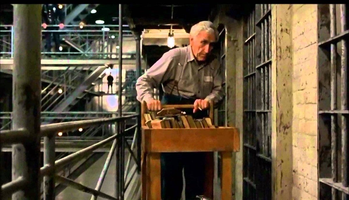 Brooks, the librarian from the shawshank redemption pushing a book cart