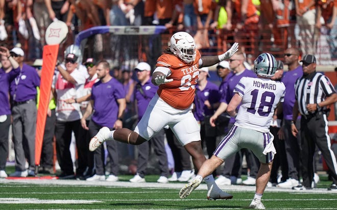 Texas Longhorns defensive lineman T'Vondre Sweat (93) tries to bat down the ball against Kansas State Wildcats quarterback Will Howard (18) in the second half of an NCAA college football game, Saturday, November. 4, 2023, in Austin, Texas.
