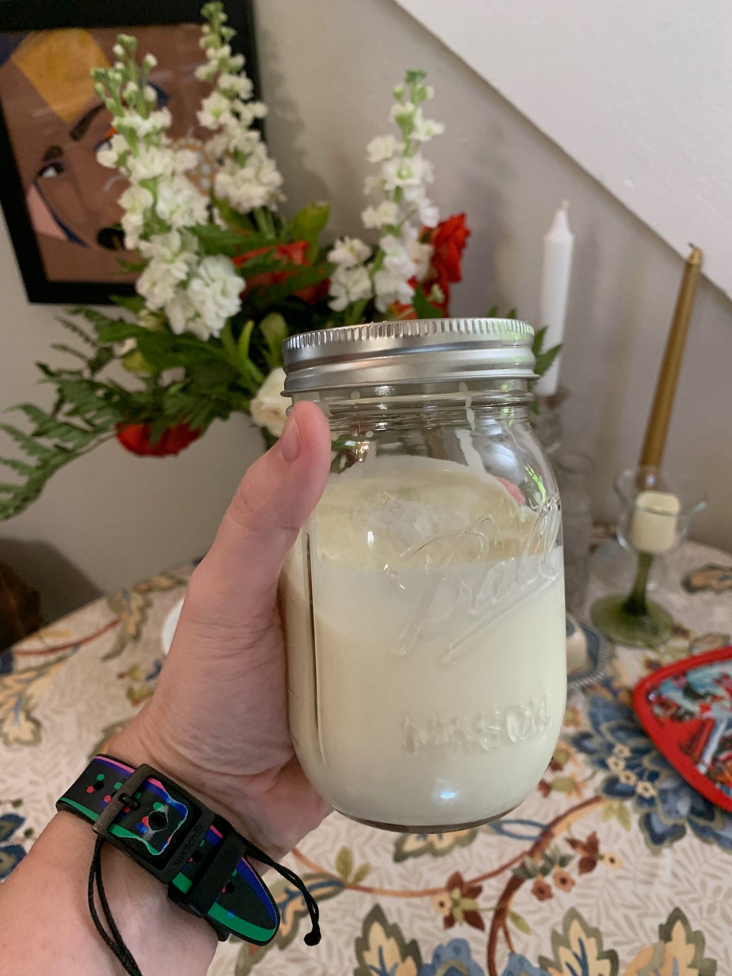 half jar of heavy whipping cream in hand