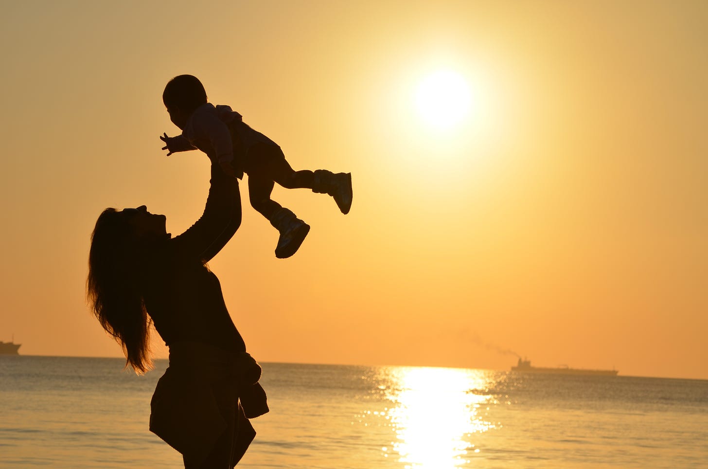 picture of woman and baby at the beach
