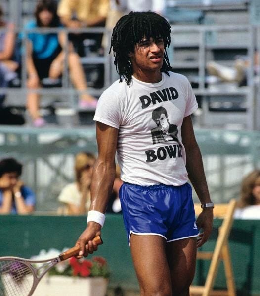 Yannick Noah in a Bowie tee shirt at practice. No such thing as official  practice gear in those days.