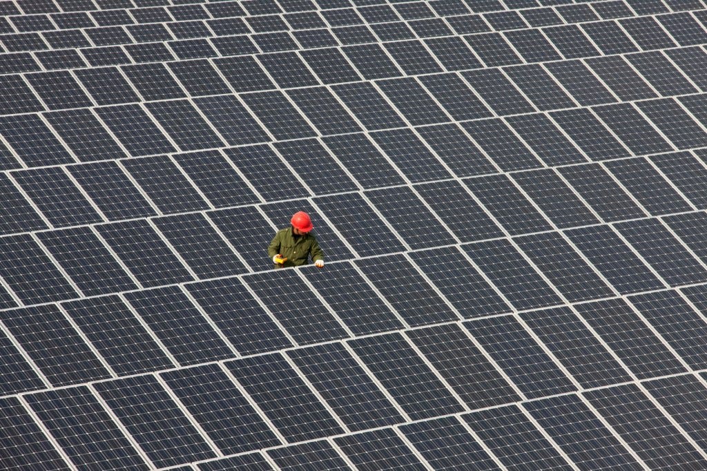 Man inspecting solar panels.