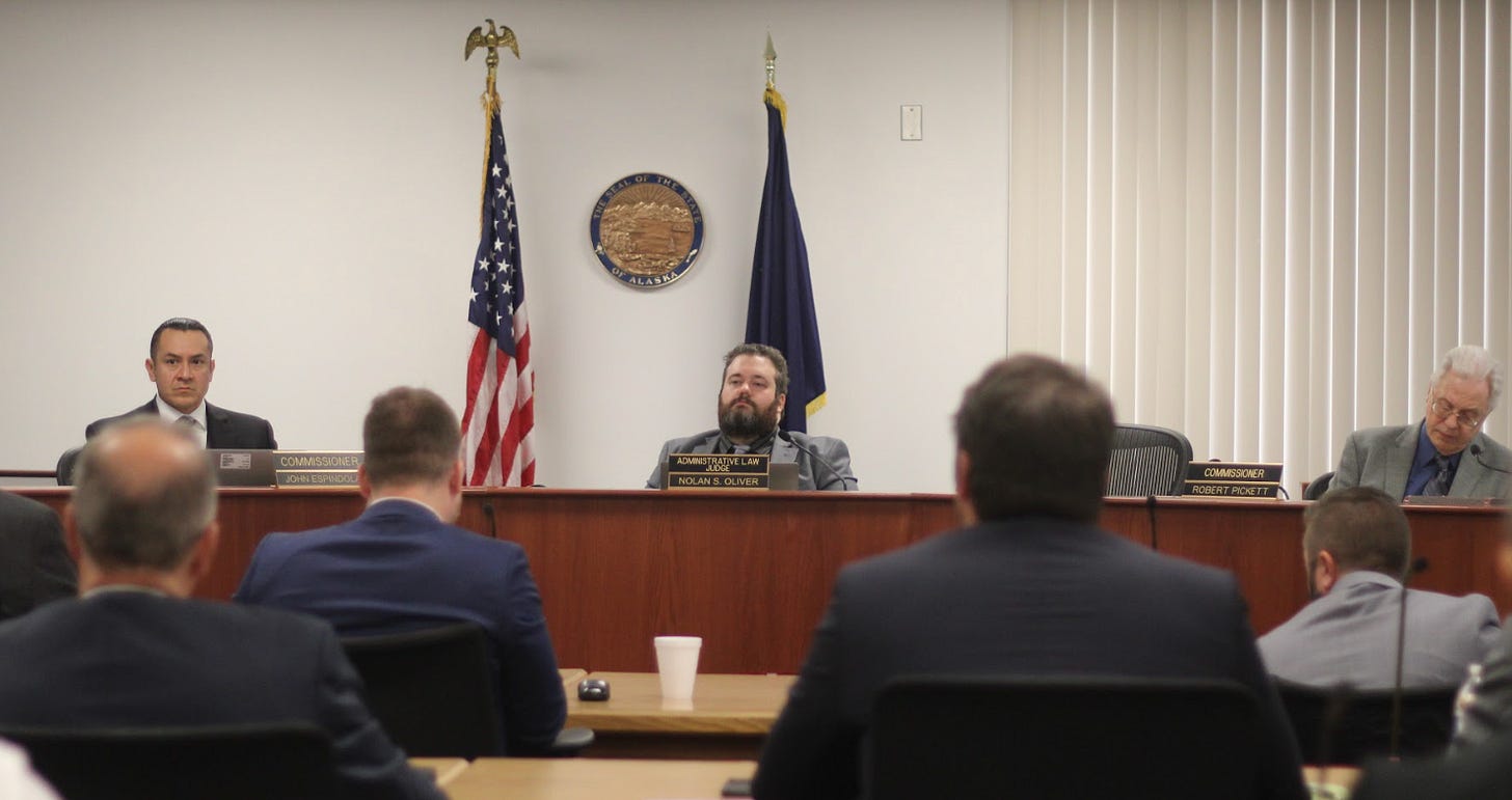 Regulatory Commission of Alaska commissioners John Espindola, left, and Bob Pickett, right, listen to testimony at a recent hearing on Chugach Electric Association's request to raise its electricity prices by 5.5%. Nolan Oliver, a state administrative law judge coordinating the hearing, is at center. (Photo by Nathaniel Herz/Northern Journal)