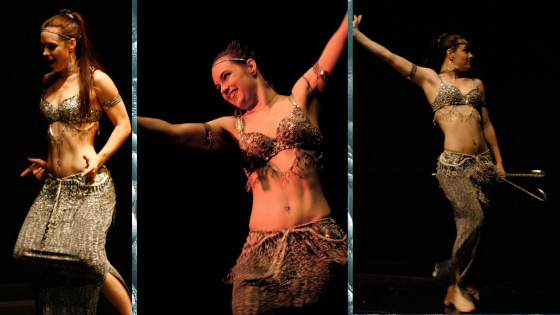 The author in a sparkly silver belly dance costume, hamming and glamming it up onstage.