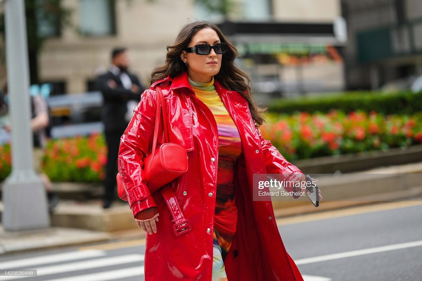 Getty Image of Bella walking in a red vinyl trench during NYFW.