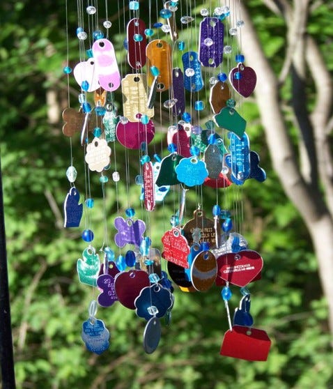 dog and cat metal identification tags strung to form wind chimes