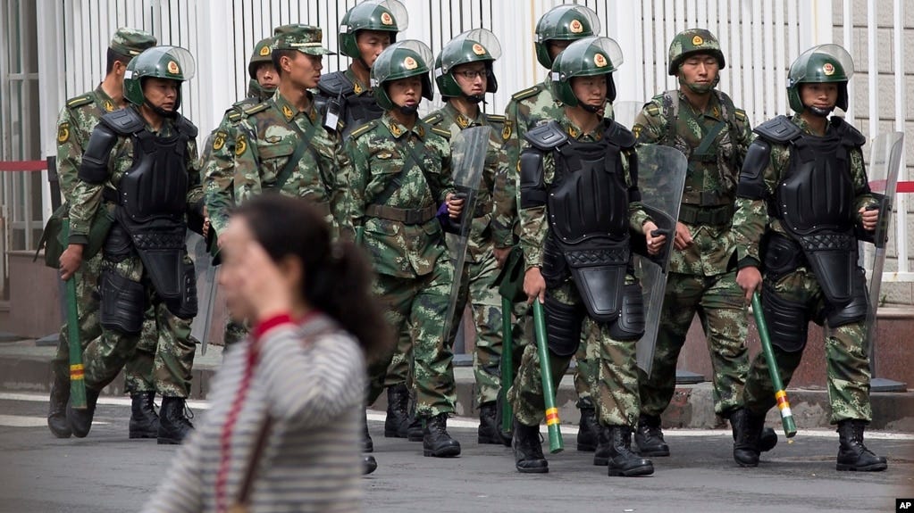 Paramilitary policemen with shields and batons patrol near the People's Square in Urumqi, China's northwestern region of Xinjiang, May 23, 2014.