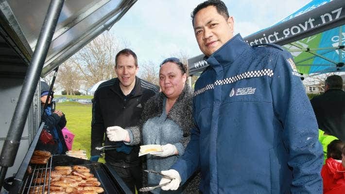Steve Ioane, right, mans the barbecue with Ra Bacon, left, and Raewyn Carter at the opening of a new playground in Ngāruawāhia.