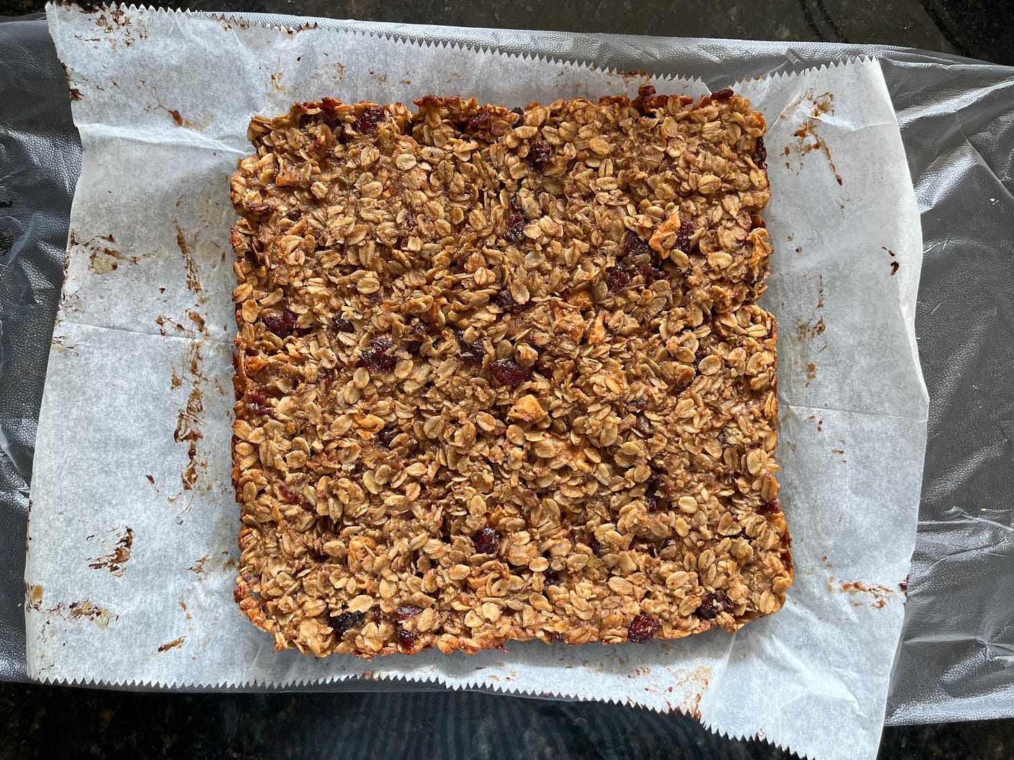 Overhead view of chewy apple-almond granola bars before they've been sliced.