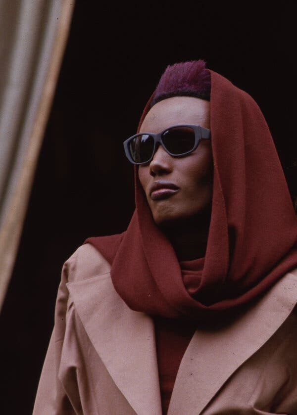 A person wearing a red scarf and sunglasses

Description automatically generated