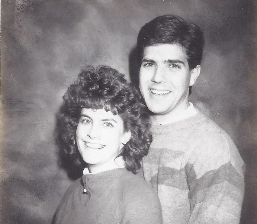 Happy young couple posed in an old-school black-and-white engagement photo like you'd see in the newspaper