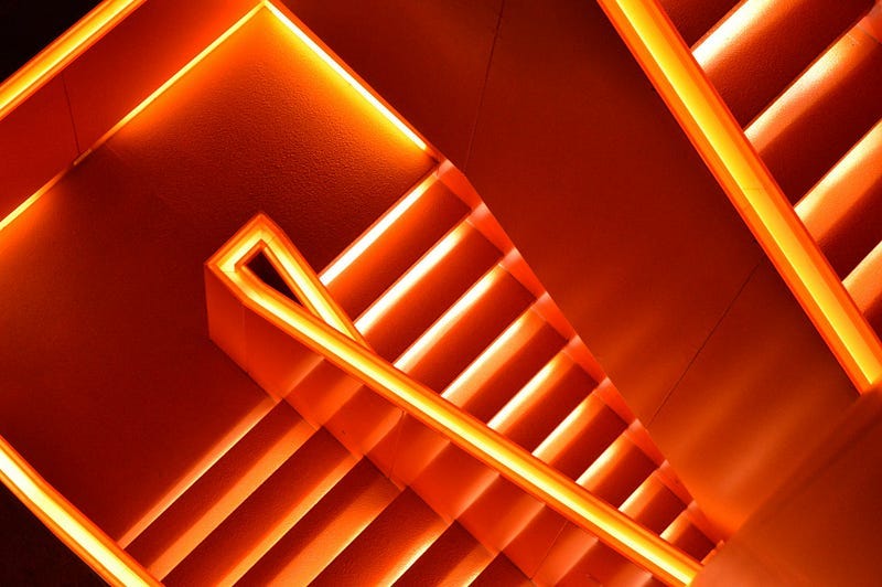 neon orange staircase with no ending