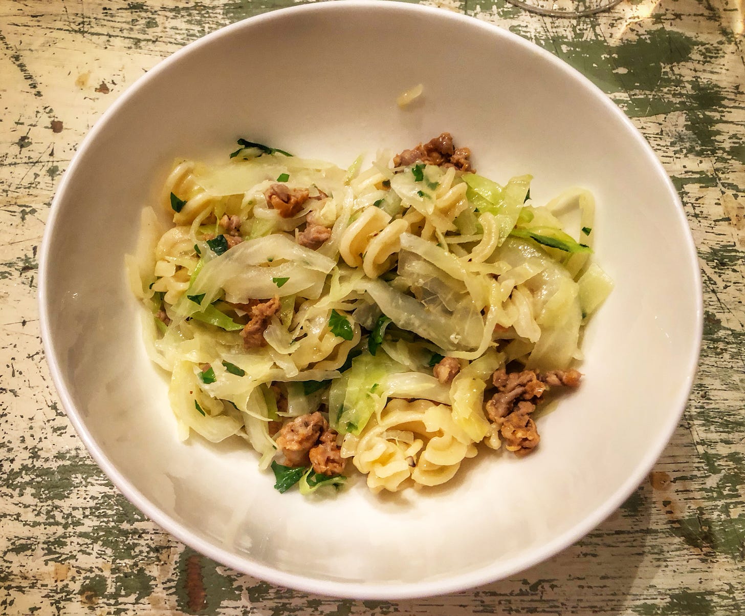 A bowl of sausage, cabbage, and Cascatelli pasta