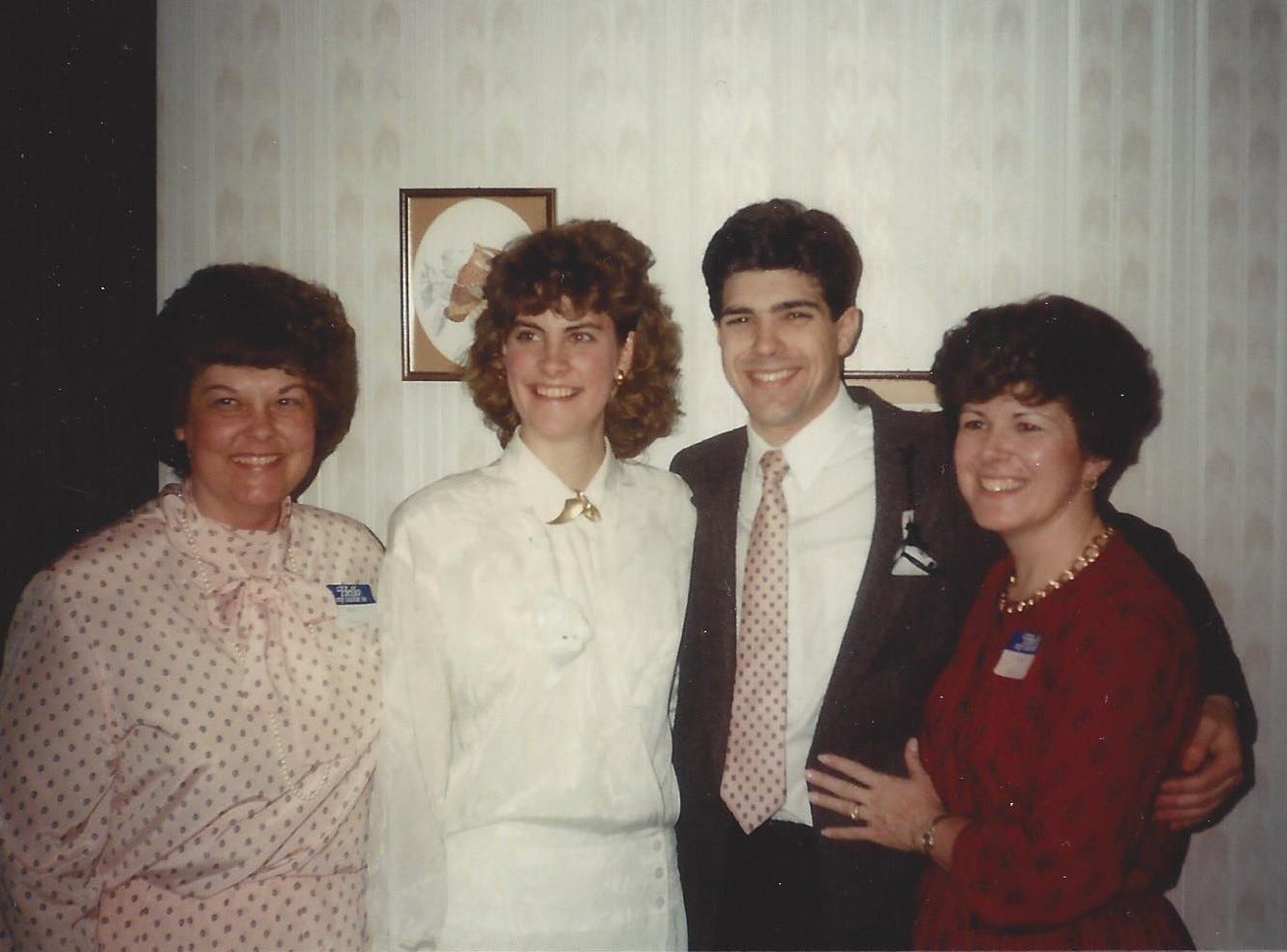 Happy couple poses with their moms at their bridal shower