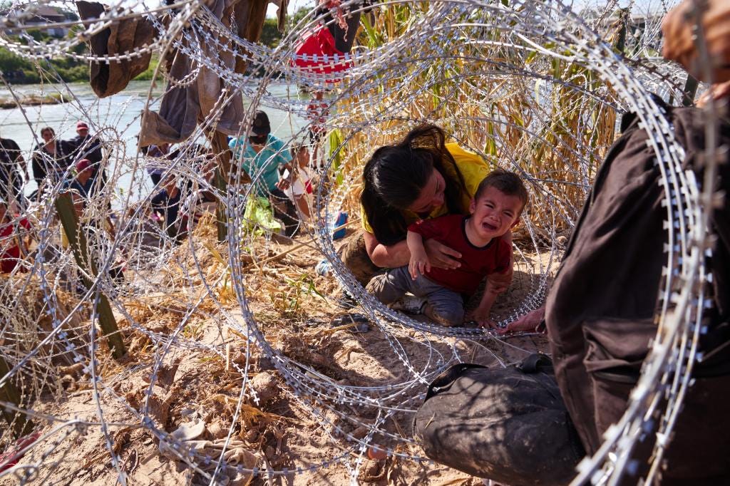  A mother from Honduras crawled through concertina wire with her three children after crossing the Rio Grande river from Mexico into the United States on Sunday, September 24, 2023 in Eagle Pass, Texas.(James Keivom for New York Post)