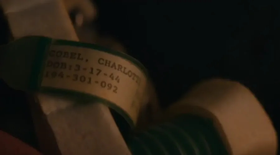 A shot of Charlotte Cobel's medical bracelet, with the date of birth 3-17-44