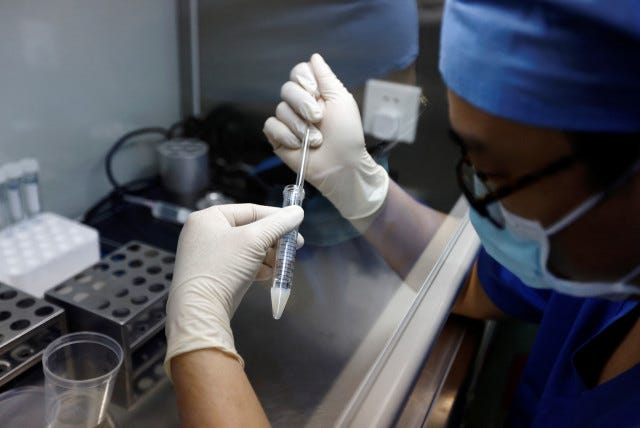 A doctor extracts semen specimen, at the embryologic laboratory of the assisted reproductive centre, at the Beijing Perfect Family Hospital, which specializes in fertility treatments, in Beijing, China April 6, 2023(photo credit: REUTERS/TINGSHU WANG)